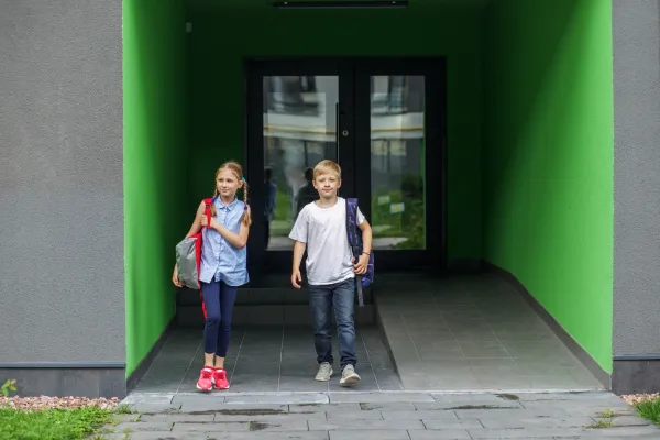 two-children-walk-out-of-school-door-classmates-w-2026-01-08-23-39-07-utc-697b8c30c2f8e